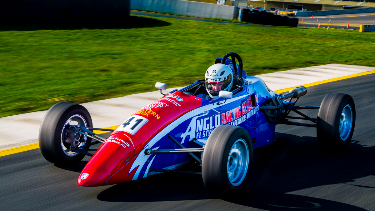 Picture of a Formula Ford race car driving towards you on track at Sydney Motorsport Park. F1 Style Driving Experience